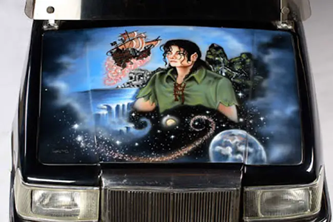 An electric Golf cart featuring an image of Jackson as Peter Pan on the hood