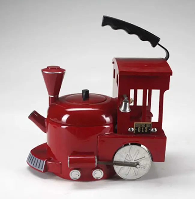 A fire engine tea kettle with moving wheels. Guide price $100-$200