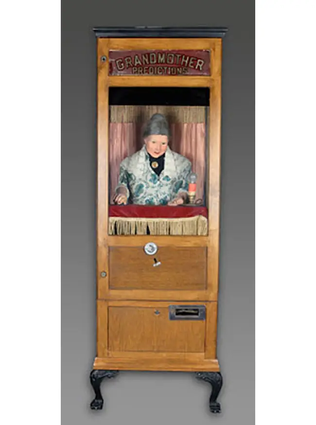 A coin-operated Grandmother Predictions fortune teller in wooden cabinet. Guide price $1,500-$2,500