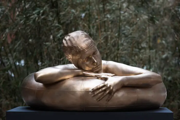 Bronze sculpture of woman in Innertube