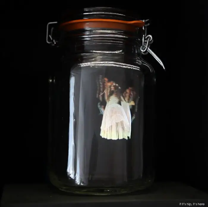 Read more about the article Holographic Fairies Caught In Jam Jars Are Musically Magical Video Sculptures.