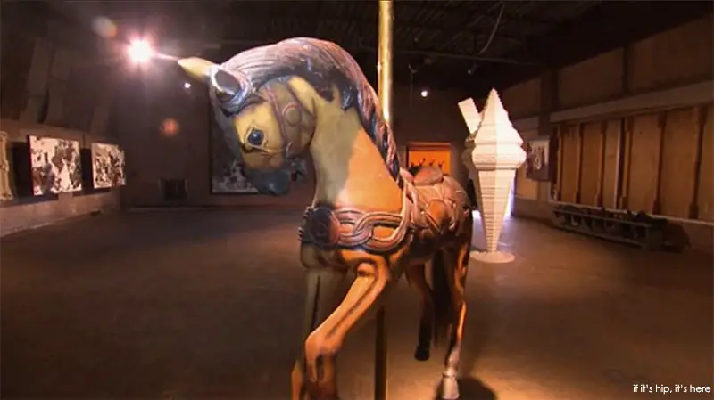 A carousel horse and a giant ice cream cone sculpture in one of the galleries