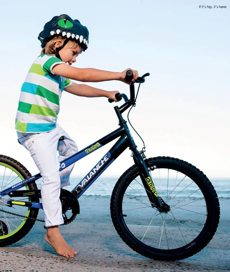 child on bike with black dragon helmet