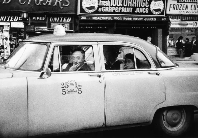 Diane Arbus (1923-1971). Taxicab driver at the wheel with two passengers, N.Y.C. 1956