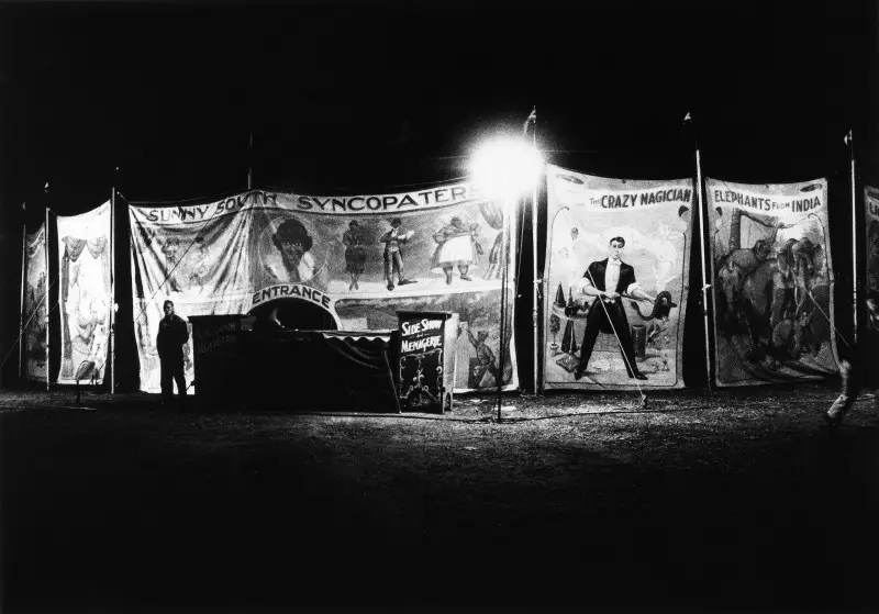 Diane Arbus, Sunny South Syncopaters and other sideshow banners at night, Palisades Park, N.J. 1957