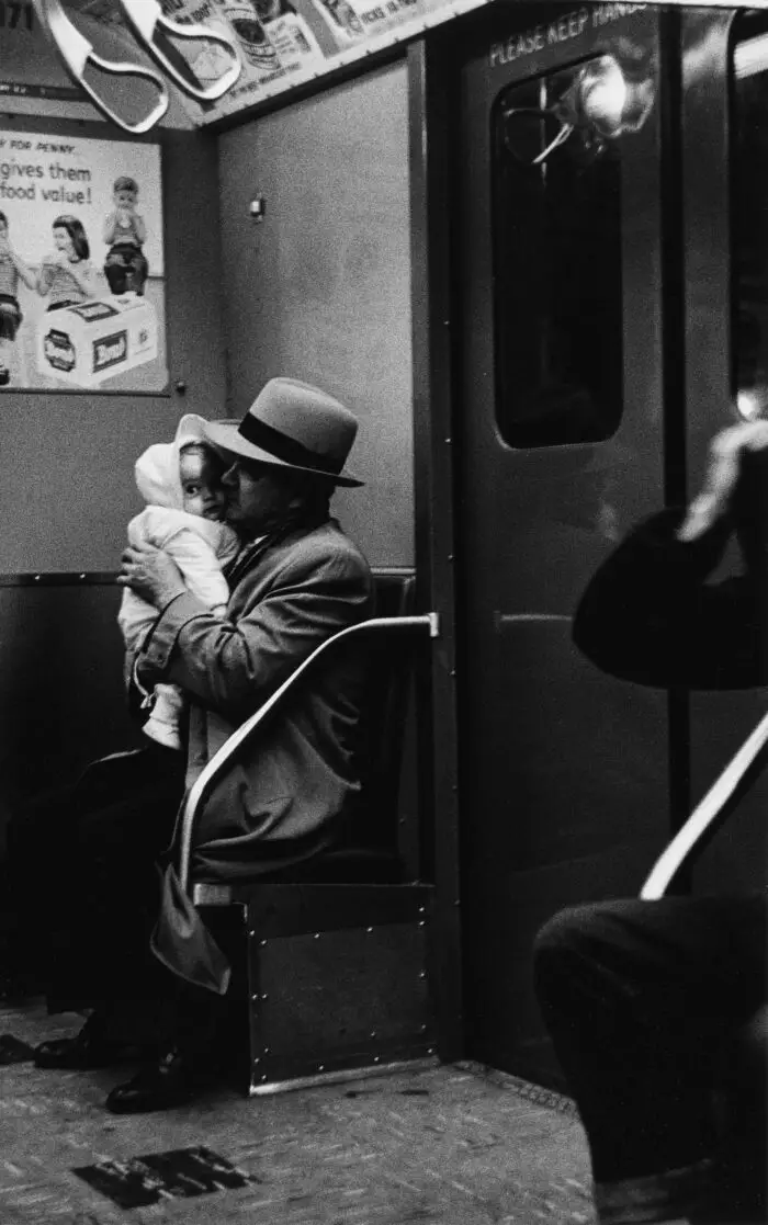Man with a curious baby on the subway, N.Y.C. 1956