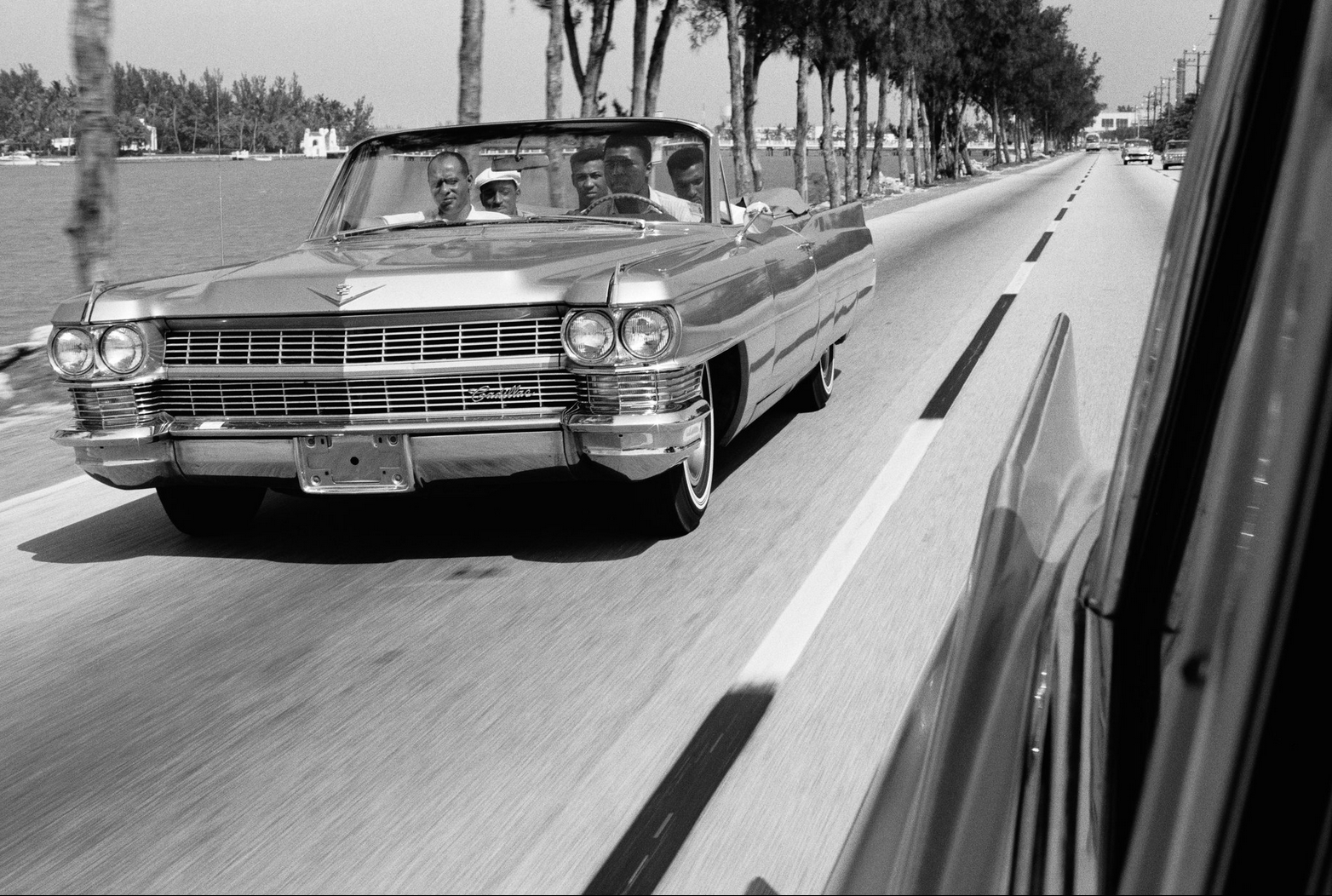 Muhammad Ali driving his Cadillac 1966.