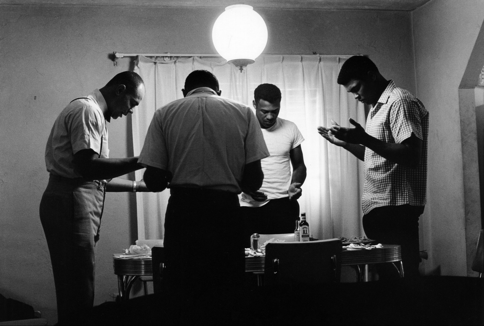 Ali prays before eating in his rented bungalow in Miami, Florida, 1966