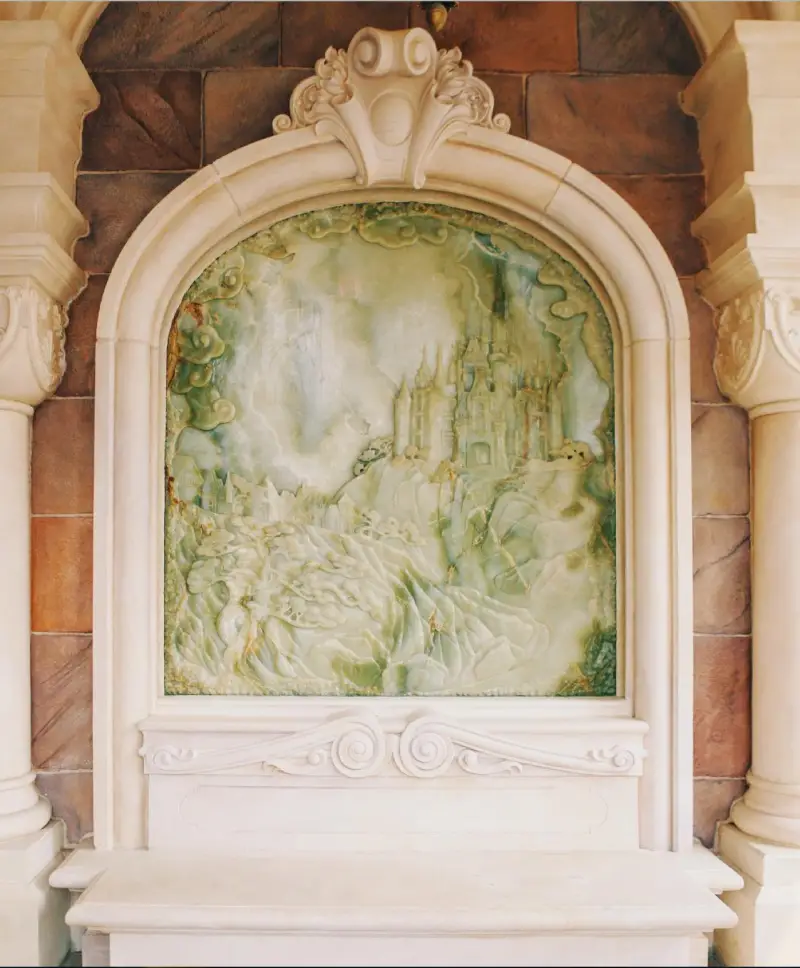 A relief carving in jade of the Magic Kingdom. Learn and see more about Shanghai Disneyland at https://www.ifitshipitshere.com/shanghai-disneyland-attractions-and-art/