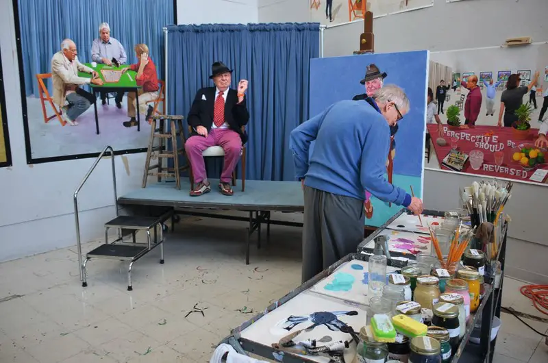 Hockney at work on his portrait of Barry Humphries in his LA studio