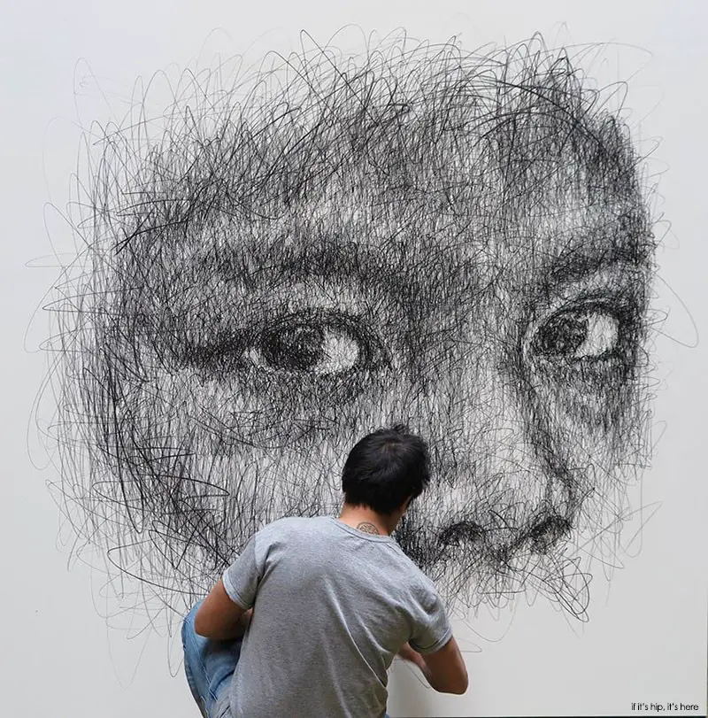 Hom Nguyen working on one of his oversized portraits