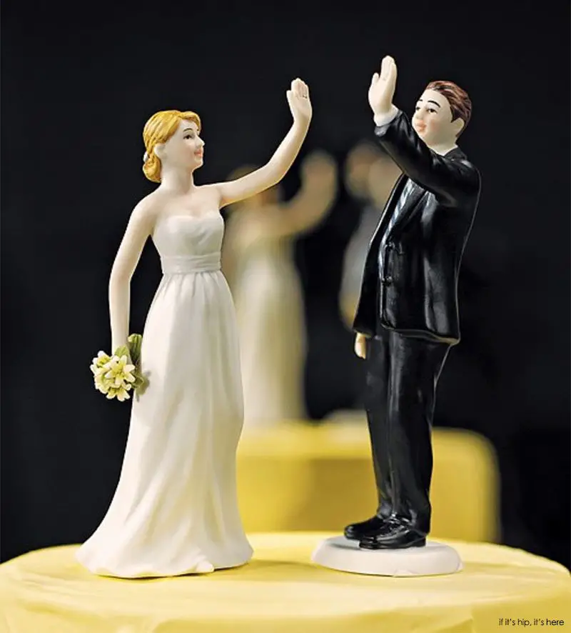 Who in their right mind would want a high-fiving bride and groom cake topper?