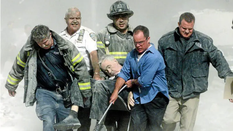 Rescue worker remove fatally injured New York City Fire Department chaplain Rev. Mychal Judge from one of the World Trade Center towers in New York City, early September 11, 2001. REUTERS/Shannon Stapleton