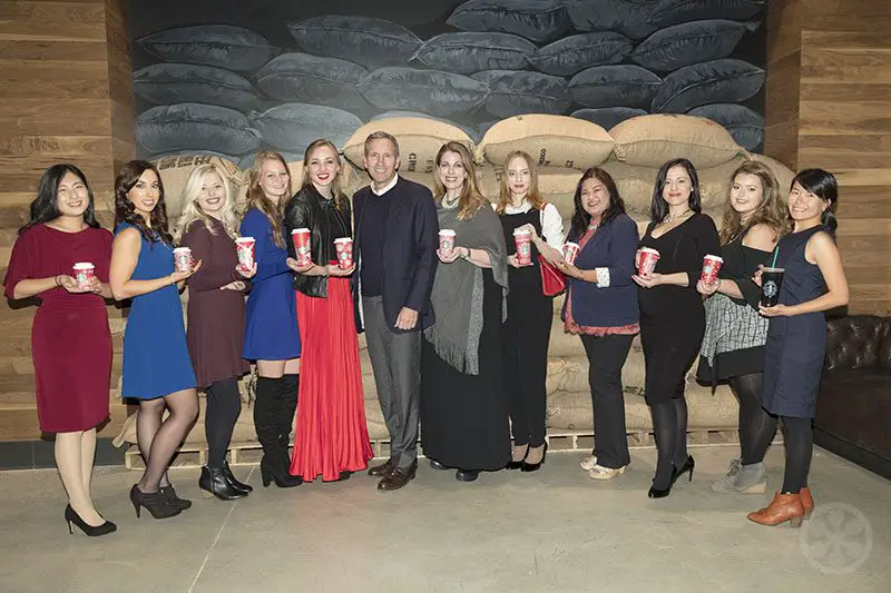 Starbucks CEO Howard Schultz with the winning red cup designers