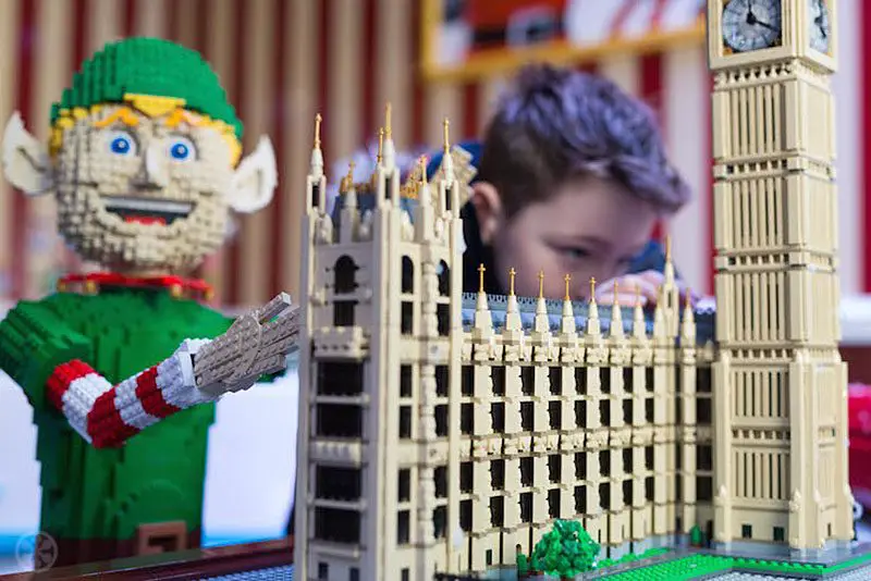 Alfie Ridout aged 8 from Hertfordshire helps putting the finishing touches to the LEGO Santa's Workshop in Covent Garden.