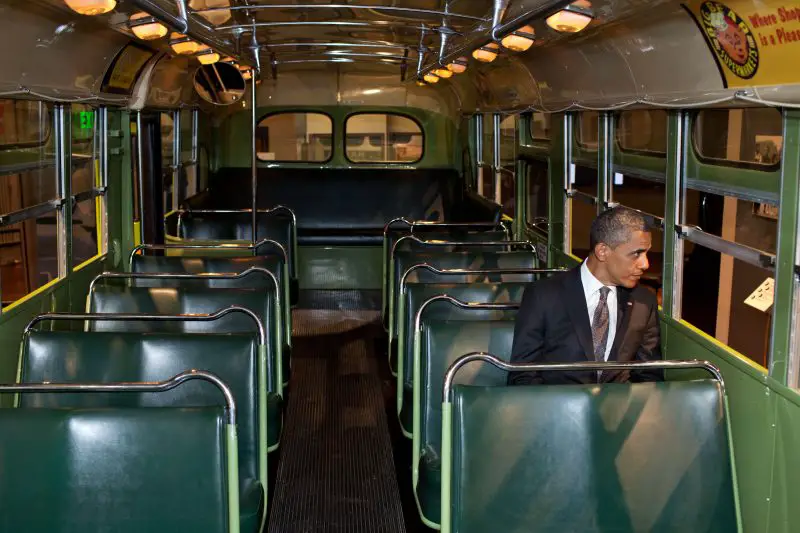 President Obama sits on the famed Rosa Parks bus at the Henry Ford Museum