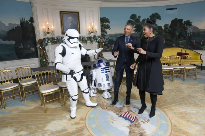President Obama and First Lady Michelle dance with a Storm Trooper and R2-D2