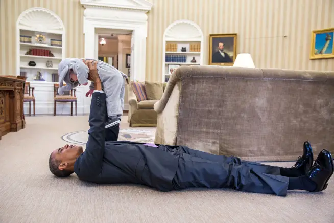 President Obama plays with Ella Rhodes in her elephant Halloween costume.