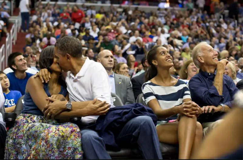 President Obama and First Lady Michelle steal a kiss during Olympic basketball game