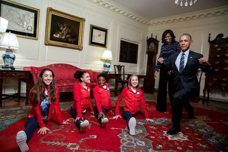 President Obama attempts the splits with the gold medal winning gymnastics team