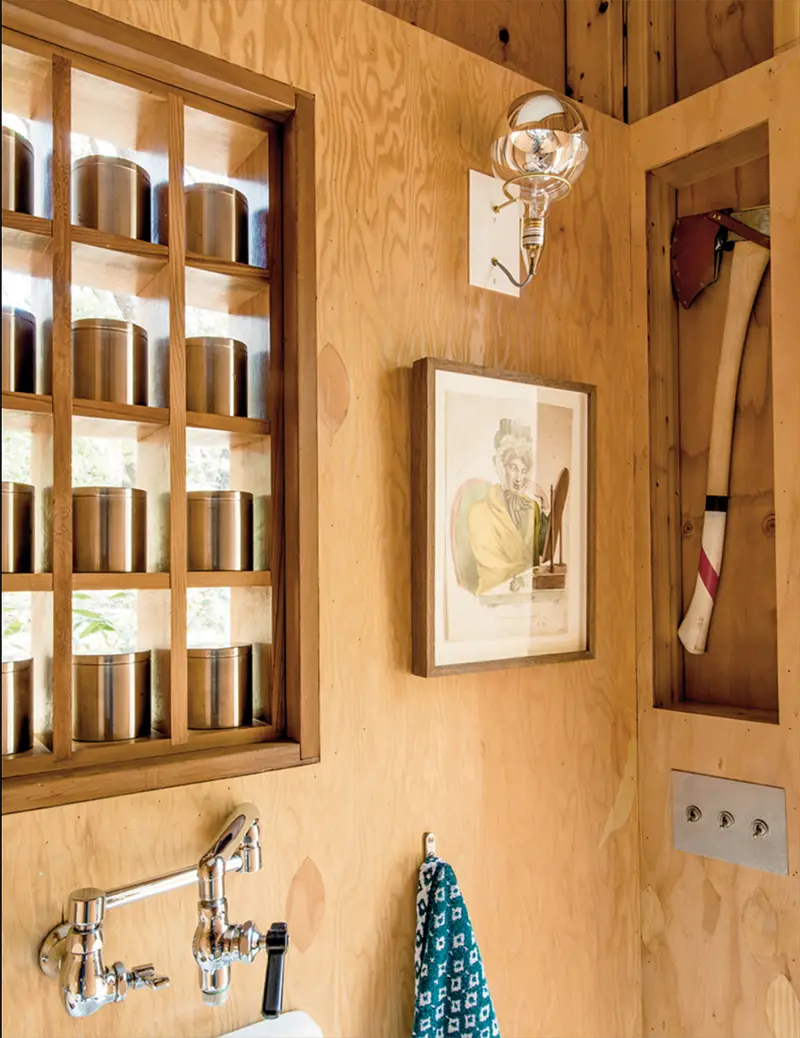 A grid of canisters lends privacy to the stand-alone bathroom