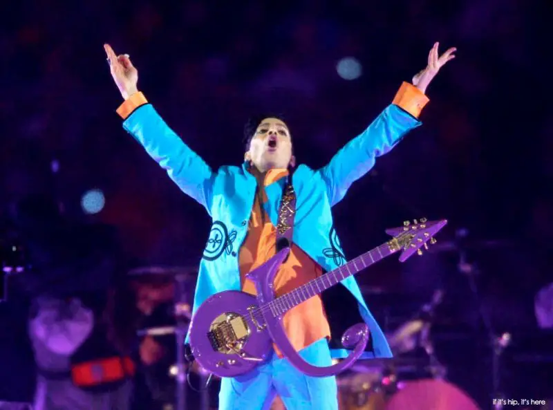Prince with his purple Love Symbol guitar