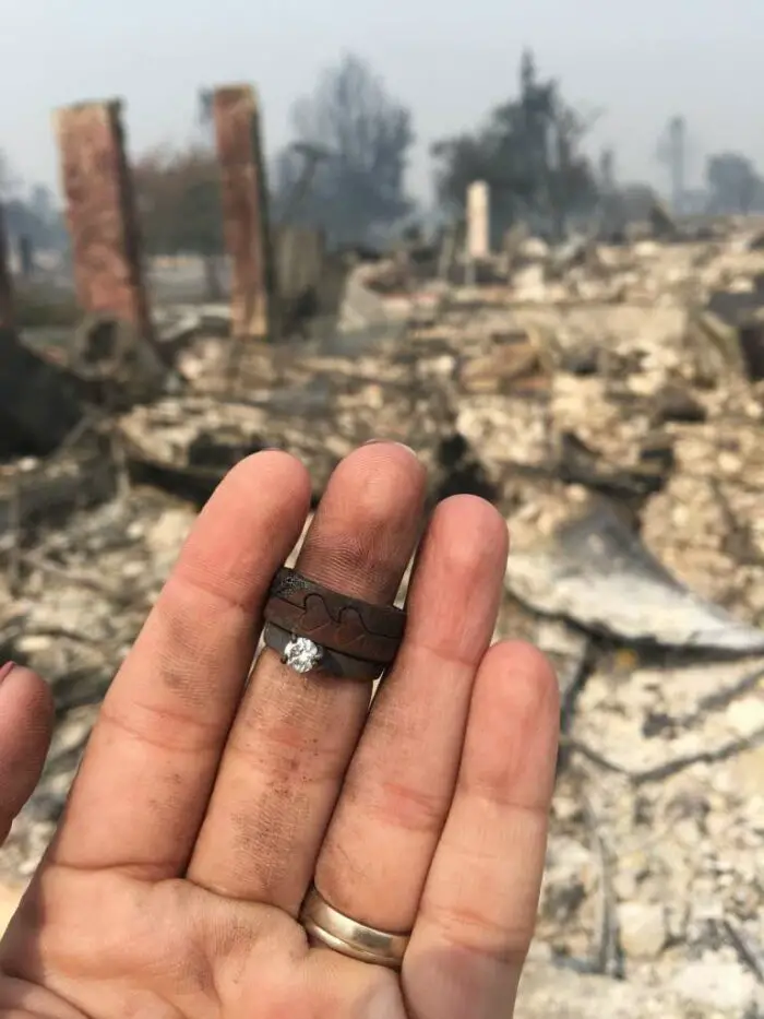 Sam Brinkerhoff's wife Monica takes a photo of her wedding ring that was found in the burned remains of her home in Santa Rosa
