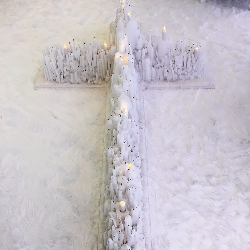 white candles on large cross
