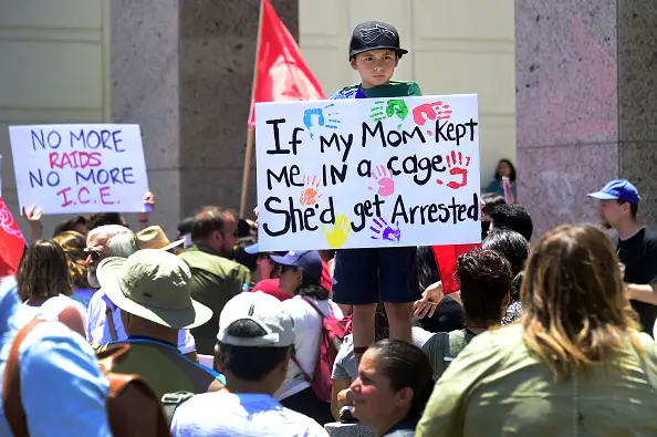 A young protester takes part in a march and rally against the separation of immigrant families June 30, 2018 