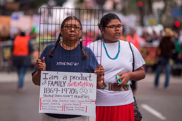 Native American women participate in a march to demand that thousands of children taken from their immigrant parents by border officials under recent controversial Trump administration policies in San Diego, California. (Photo by DAVID MCNEW / AFP)