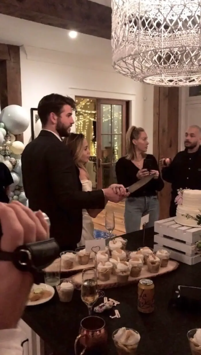 Miley and Liam cut the wedding cake