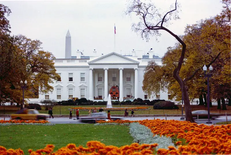 The front of the White House decorated for Halloween with a giant jack-o'-lantern over the door (1973)