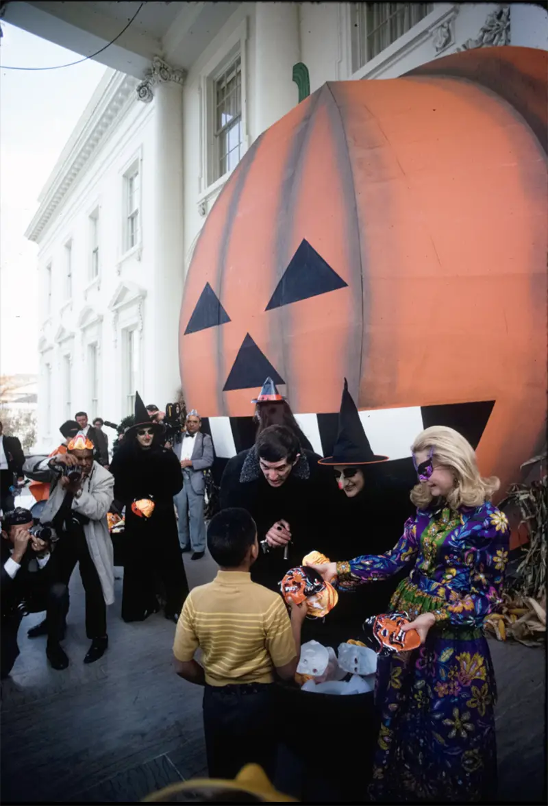 Tricia Nixon and actor Jonathan Frid handed out treats to costumed children entering the White House North Portico for a Halloween Party 1969