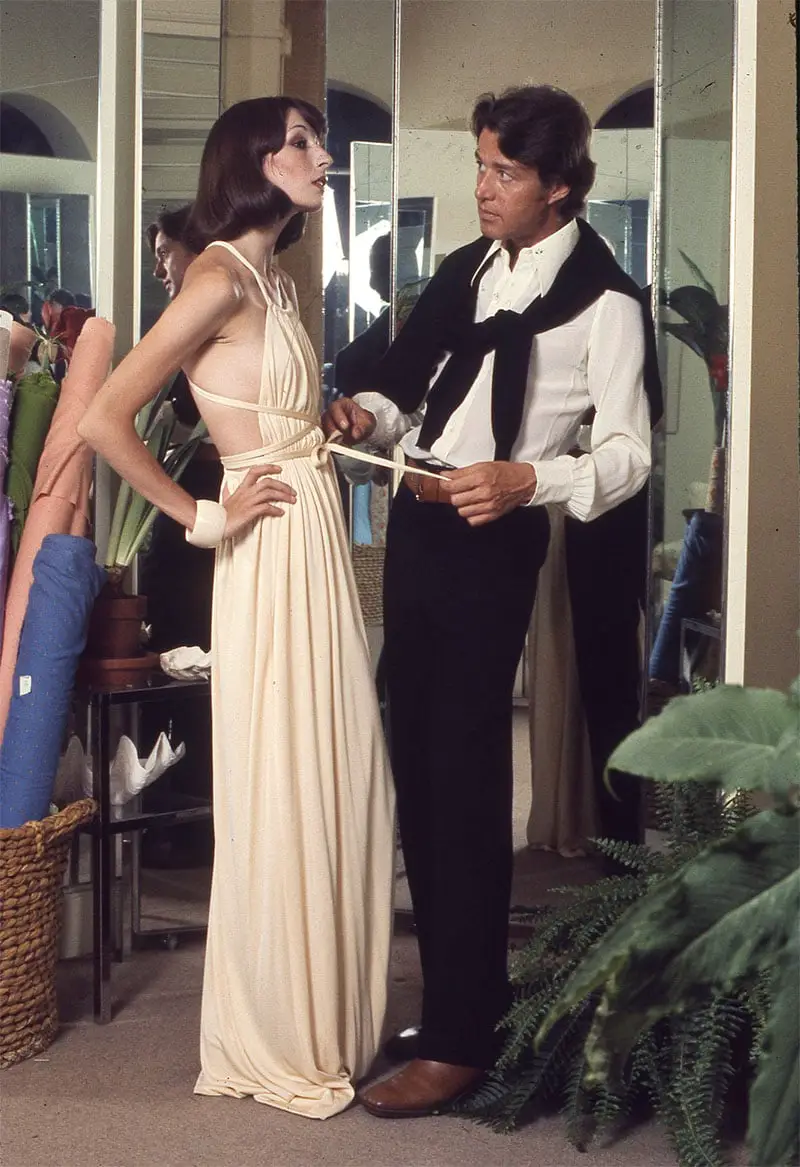 Fashion designer Roy Halston dressing Angelica Huston 