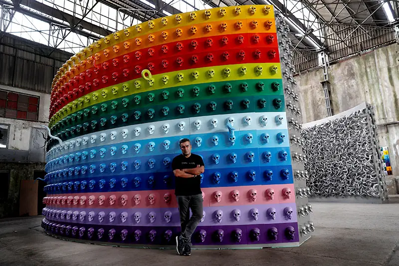 Turkish artist Gunestekin poses next to with his artwork "Chamber of Immortality" in Istanbul