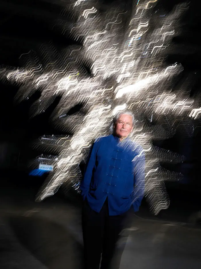 Ingo Maurer in front of his giant Baccarat Crystal Snowflake for UNICEF