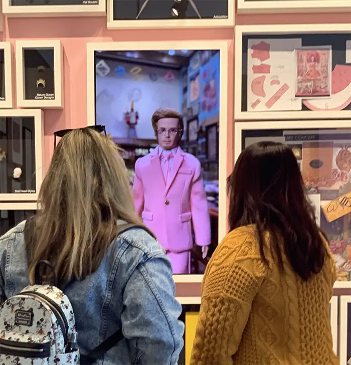 A video featuring the Mark Ryden doll and Barbie played in the center of the pink painted wall. 