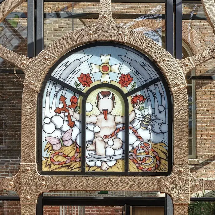 stained glass baby jesus with devil horns