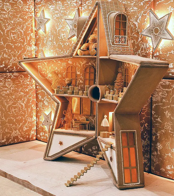 a close look at the gingerbread star shaped dollhouse in the baby Dior window above.