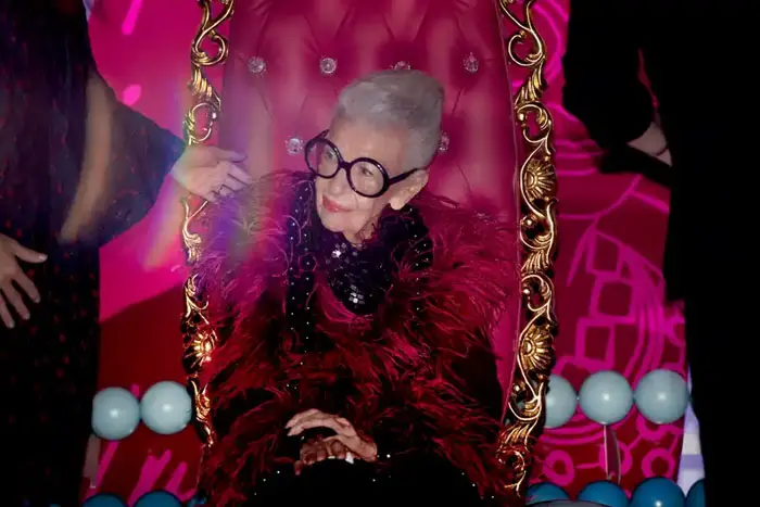 Iris Apfel posing for photos beneath her Surfboard Tree