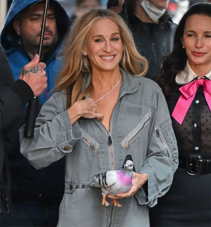 Actress Sarah Jessica Parker holding the JW Anderson pigeon clutch while filming the second season of And Just Like That.