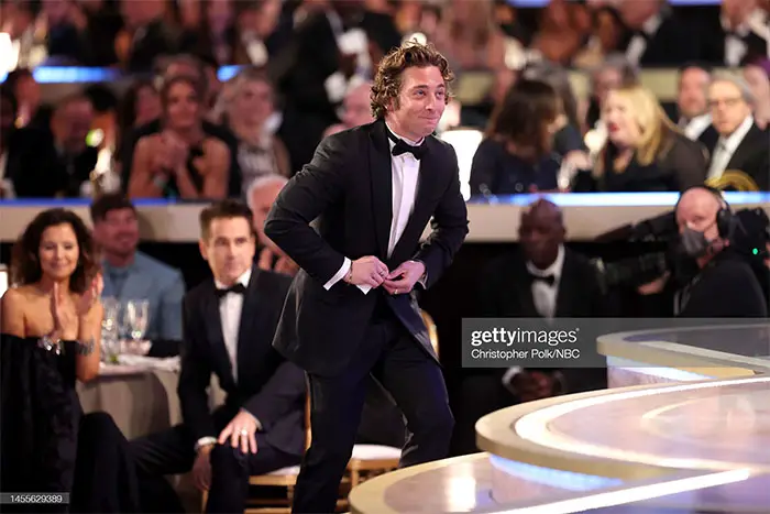 Jeremy Allen White ascending stairs