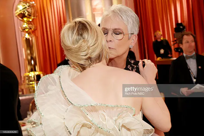 Michelle Williams and Jamie Lee Curtis greet one another affectionately