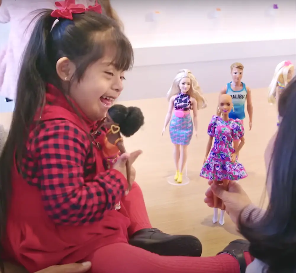 down syndrome child playing with dolls