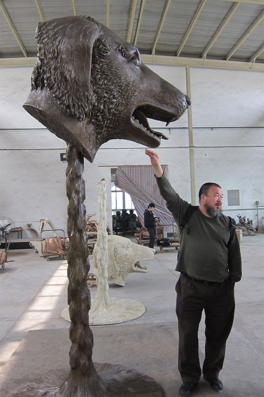 Artist Ai Weiwei with his Dog sculpture from Circle of Animals / Zodiac Heads