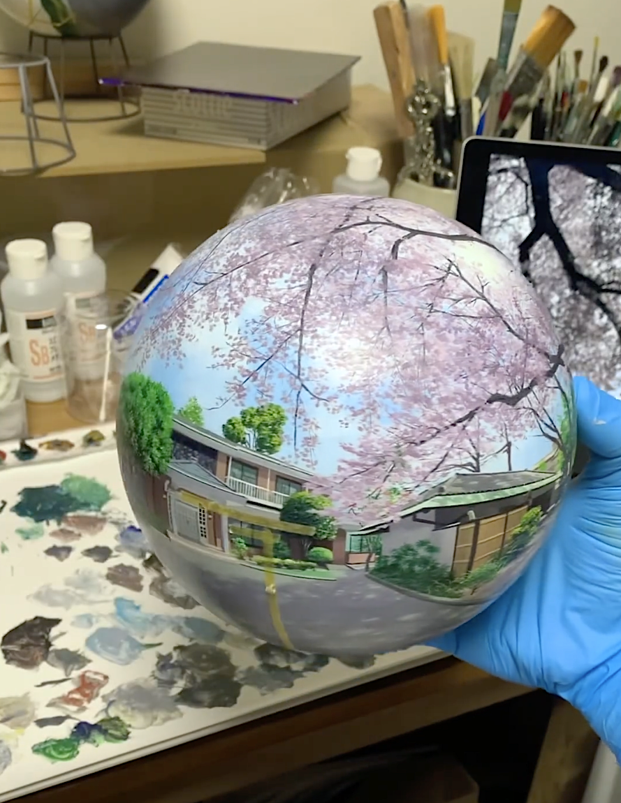 artist painting on a ball