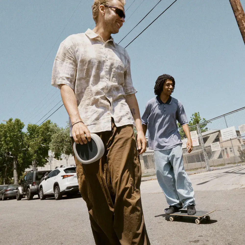 skateboarders holding wireless speaker